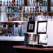 Melitta Cafina XT6 Commercial Coffee Machine on a counter in bar - Absolute Drinks