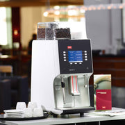 Melitta Cafina XT4 Commercial Coffee Machine on a counter in restaurant - Absolute Drinks